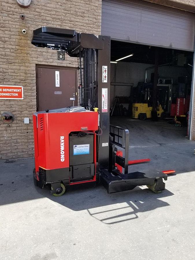 Side view of CSA-certified Raymond EASI 4D-R45TT multi-directional reach truck with triple mast – staged in Brampton ON
