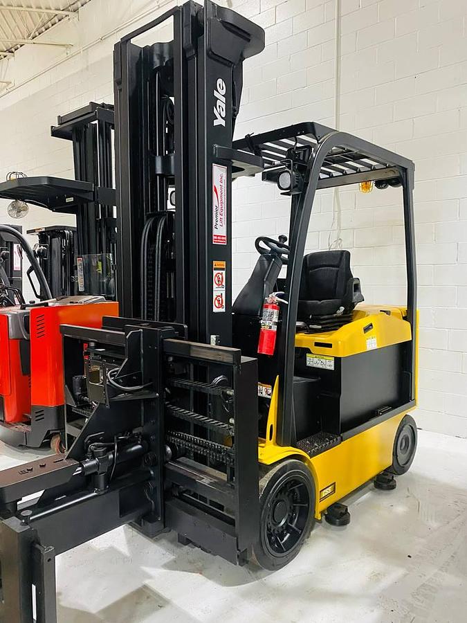 Front side view of refurbished 2014 Yale ERC080VHN electric cushion tire forklift showing superior swing mast attachment, 48" forks, CSA certification decal, and operator compartment during U.S. deployment.
