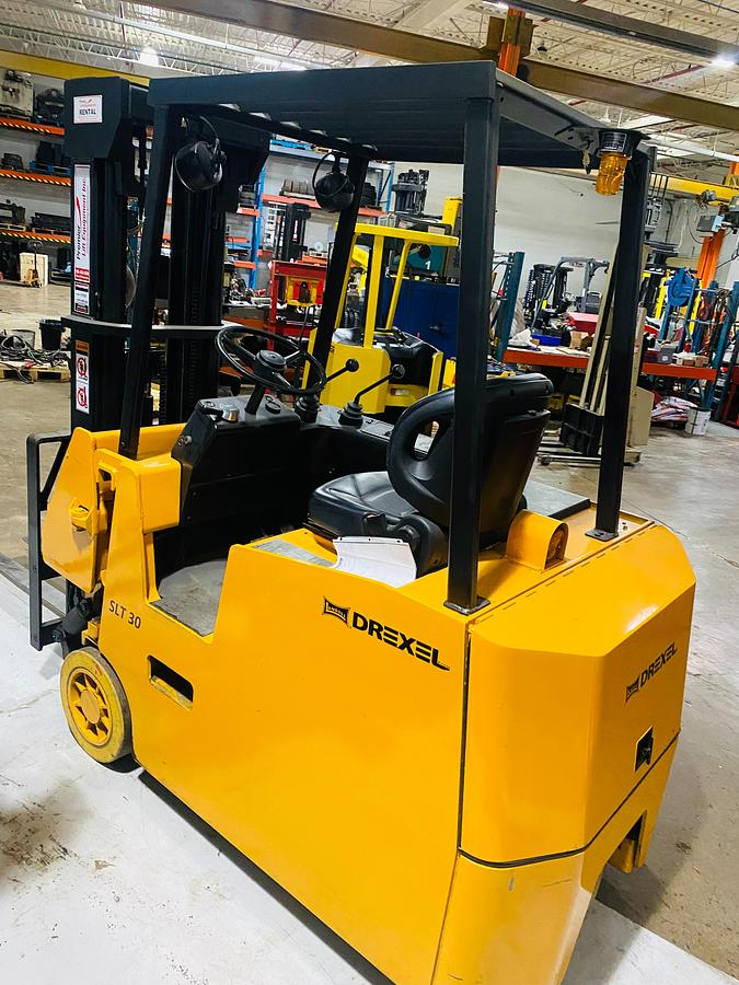 Opposite back side angled view of Drexel SLT30 electric swing mast forklift showing rear tires, counterweight, and CSA-certified chassis – unit staged in Brampton ON