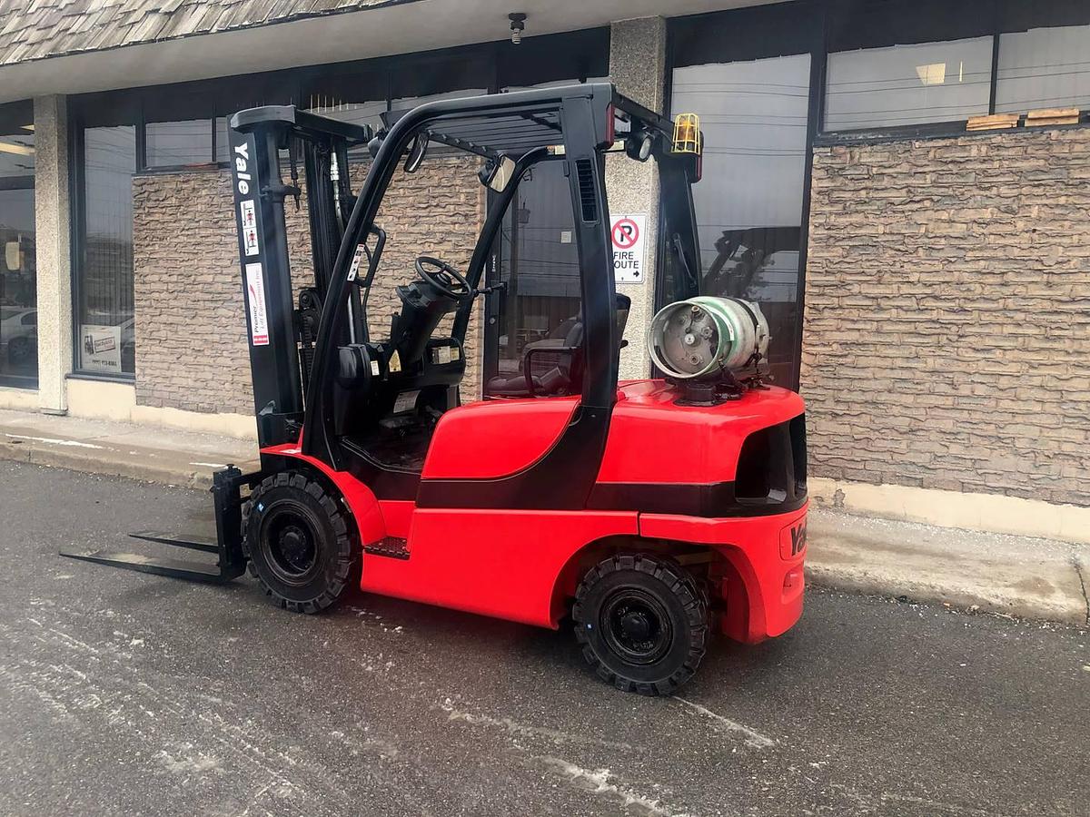 Side view of refurbished 2011 Yale GLP050VX LP Gas forklift showing 42" forks, 240" quad mast, solid pneumatic tires, propane powertrain, and CSA certification decal during Ontario deployment.