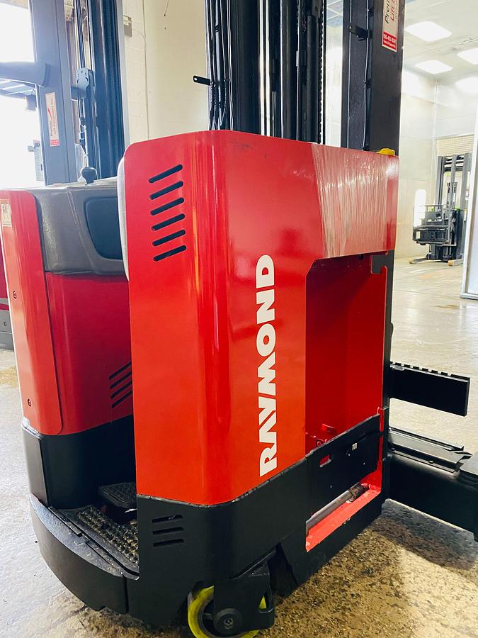 Close-up view of Raymond EASI 4D-R45TT electric reach truck showing chassis frame, operator compartment, steering wheel, and CSA safety decals during Brampton deployment