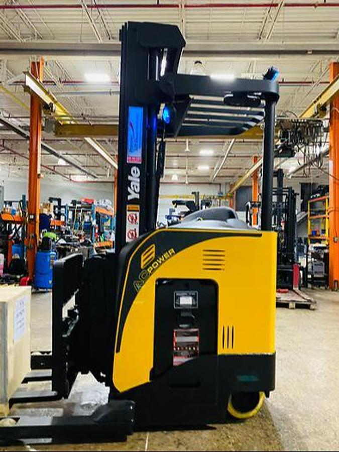Side view of Yale NDR035EB electric deep reach forklift – CSA-certified 3,500 lb chassis featuring 266” triple mast, pantograph reach carriage, 42” forks with side shift, and ergonomic stand-up operator compartment staged in Brampton ON – Premier Lift Equipment