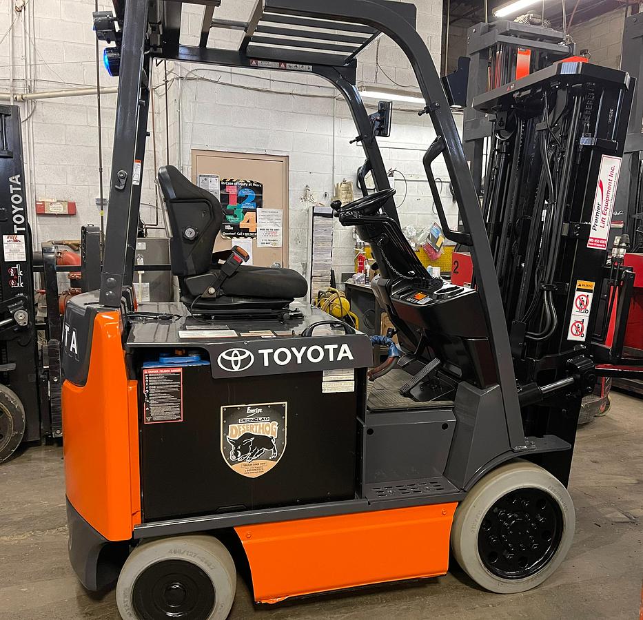 Opposite side view of 2019 Toyota 8FBCU25 electric forklift showing mast rails, CSA decals, and chassis profile during Brampton deployment