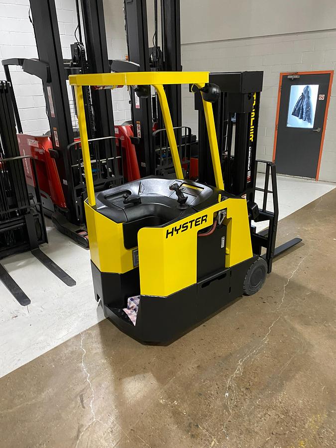 Rear-right angle view of Hyster E30FR-24 electric dockstocker showing stand-up rider platform, rear-wheel drive configuration, and CSA-certified chassis – unit staged in Brampton ON