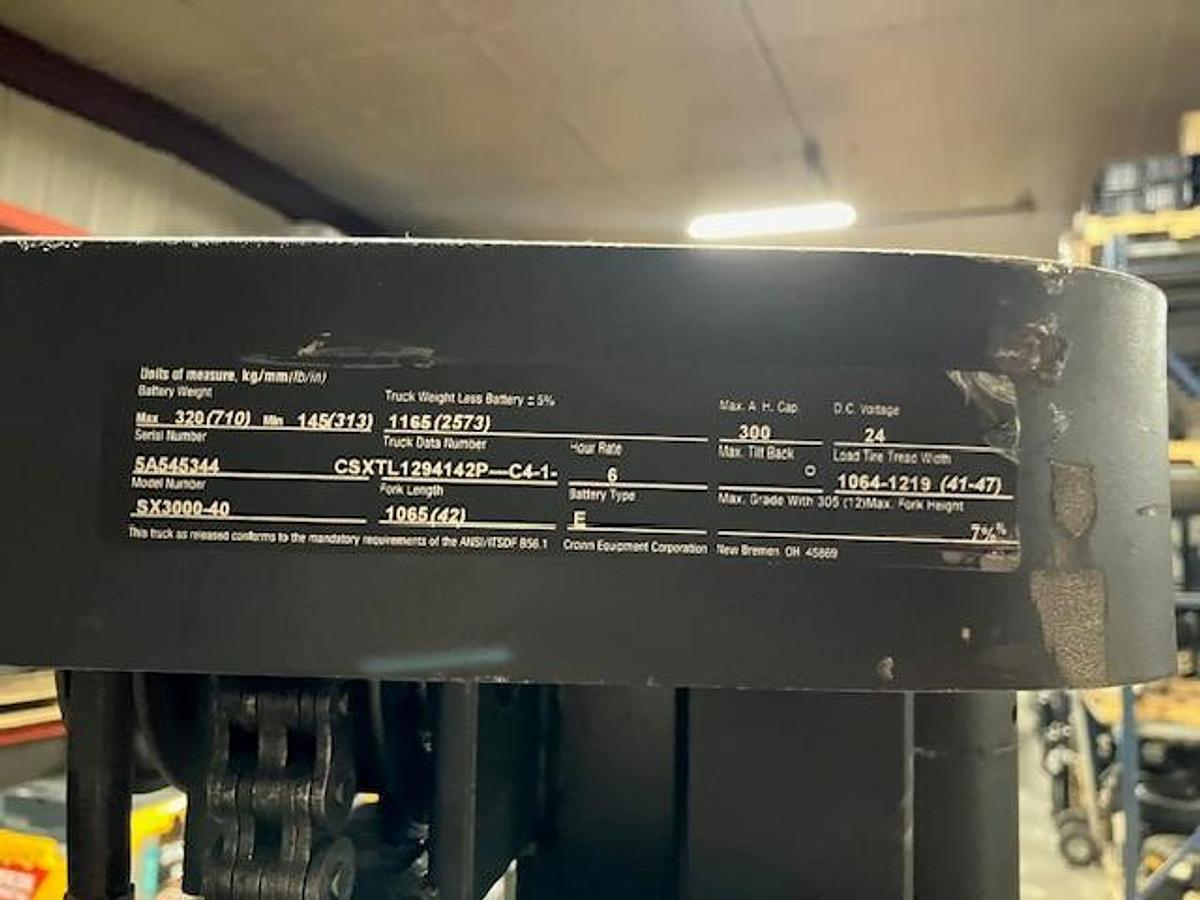 Close‑up of manufacturer data tag on Crown SX3000‑40 showing model, serial number, and capacity plate details.