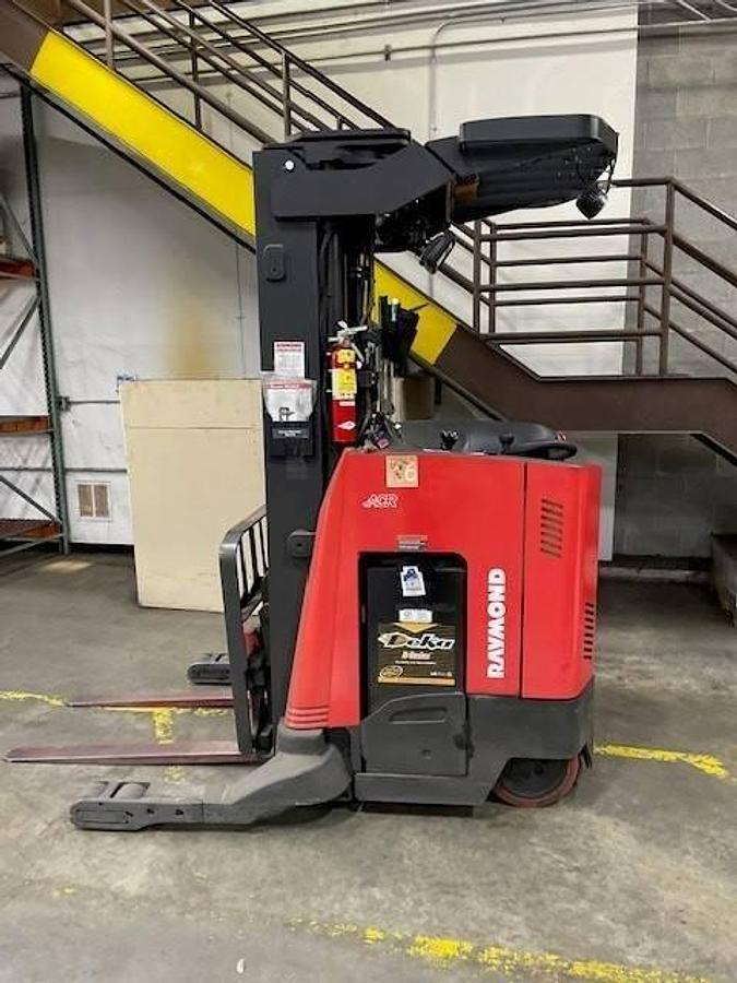 Opposite side view of refurbished 2020 Raymond 730-R35TT electric reach truck showing reach mechanism, drive unit cover, and chassis structure during Brampton deployment