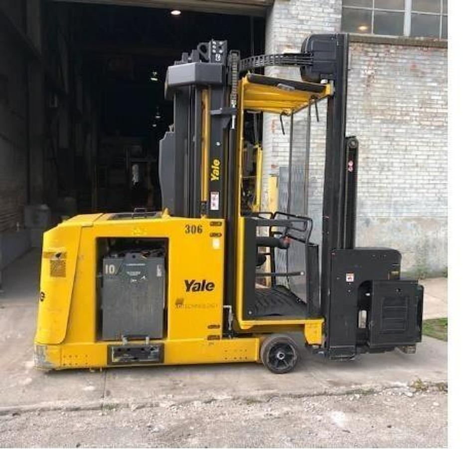Side view of refurbished 2013 Yale NTA030SB electric man‑up swing reach turret truck showing turret mast articulation, CSA certification decal, and operator cab during Ontario deployment.