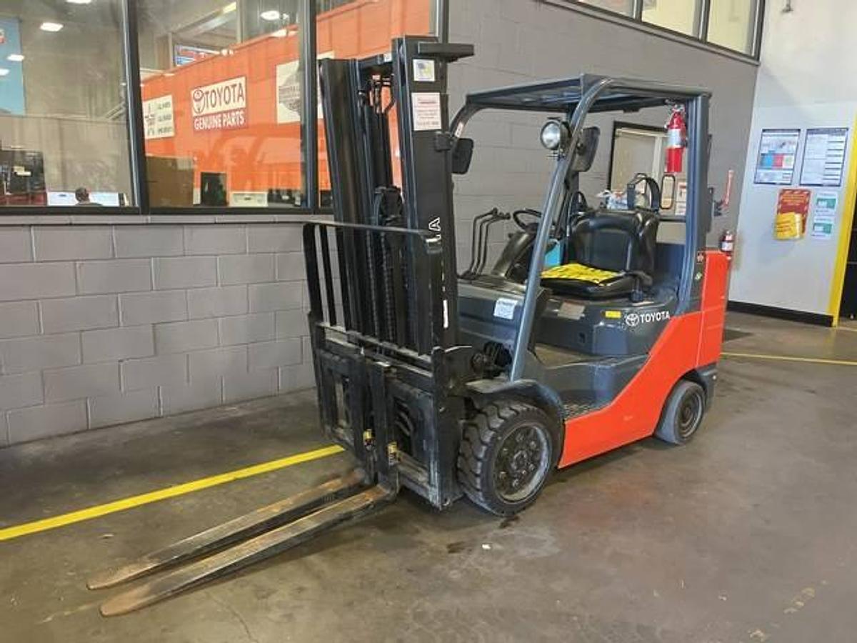 Front side view of refurbished 2018 Toyota 8FGCU30 LP gas forklift showing triple mast, 42" forks, and solid cushion tires during Brampton deployment