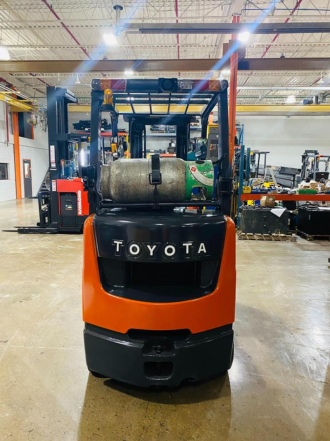 Back view of 2019 Toyota 8FGCU20 propane forklift – CSA-certified 3,400 lb cushion tire chassis showing rear counterweight, propane tank mount, and safety decals applied, Brampton ON – Premier Lift Equipment
