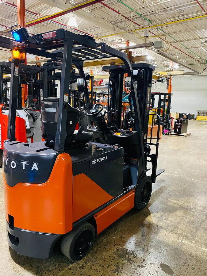 Rear view of Toyota 8FBCU32-EE electric forklift highlighting counterweight, EE decals, and CSA certification during warehouse deployment