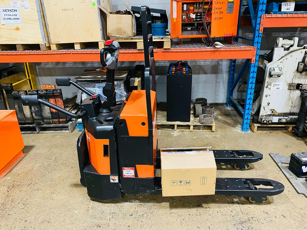 Side view of refurbished 2011 BT LPE200/8 electric walkie/rider pallet jack showing 27" x 45" forks, flip‑down operator platform, and CSA certification decal during Ontario deployment.