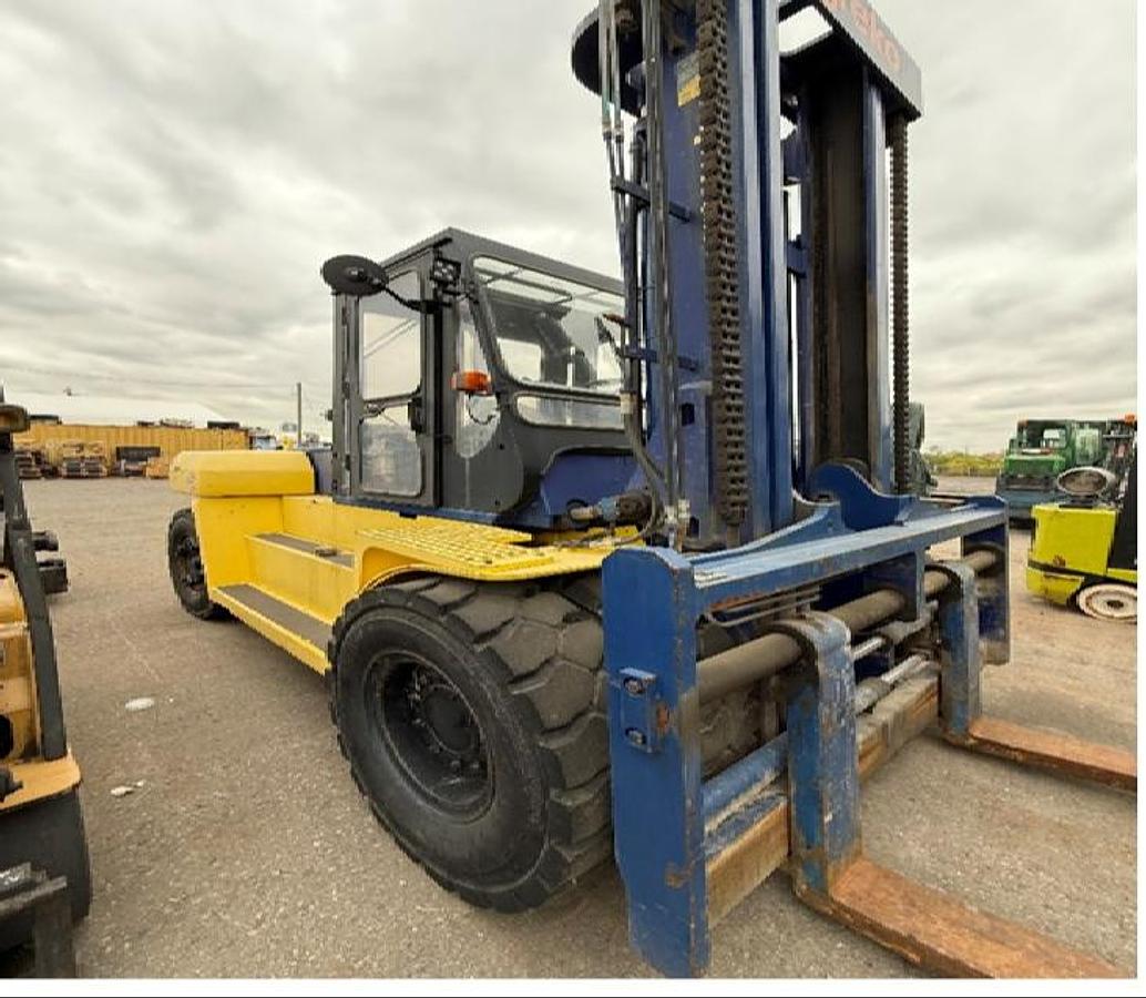 Komatsu FD135T‑6 30,000 lb diesel pneumatic forklift with full cab, dual pneumatics and 157‑inch mast positioned for heavy‑capacity industrial loading.
