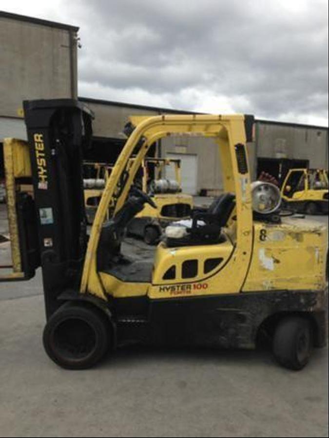 Side profile of 2010 Hyster S100FT LPG cushion forklift showing mast rails, chassis layout, and indoor tires during Brampton deployment