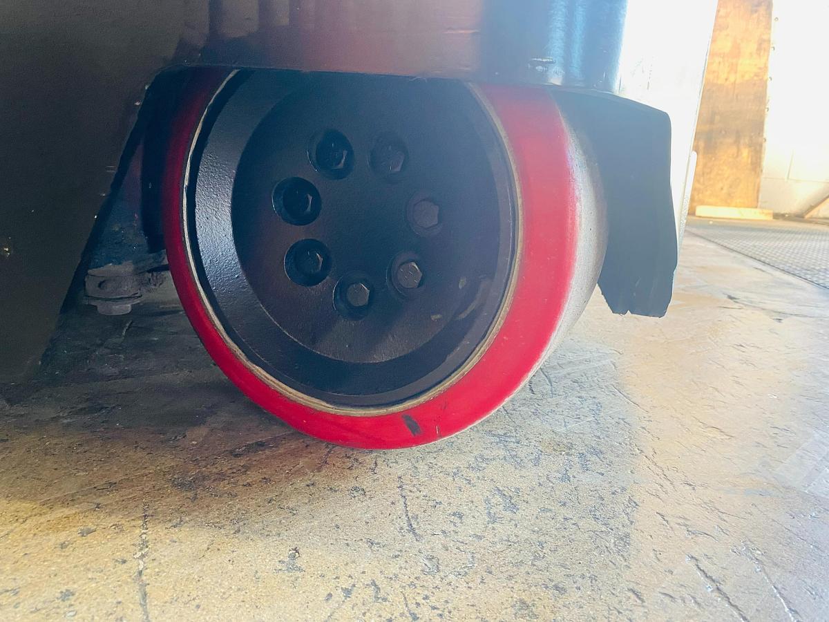 New rear drive tire installed on Raymond 750-R45TT reach truck – poly cushion tire replacement for improved traction and smooth indoor warehouse operation