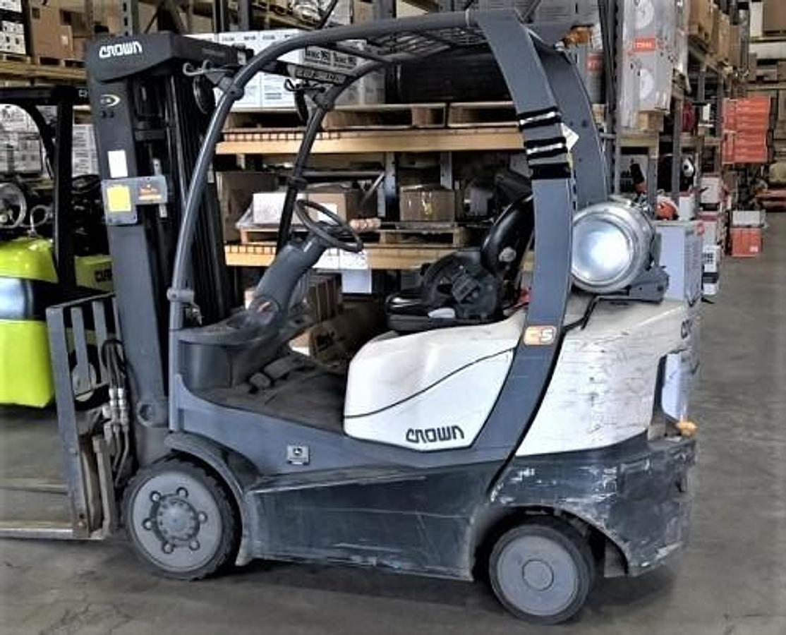 Side view of refurbished 2015 Crown C5100‑50 propane forklift showing solid tires, triple side shifter, and CSA certification decal during Ontario deployment.