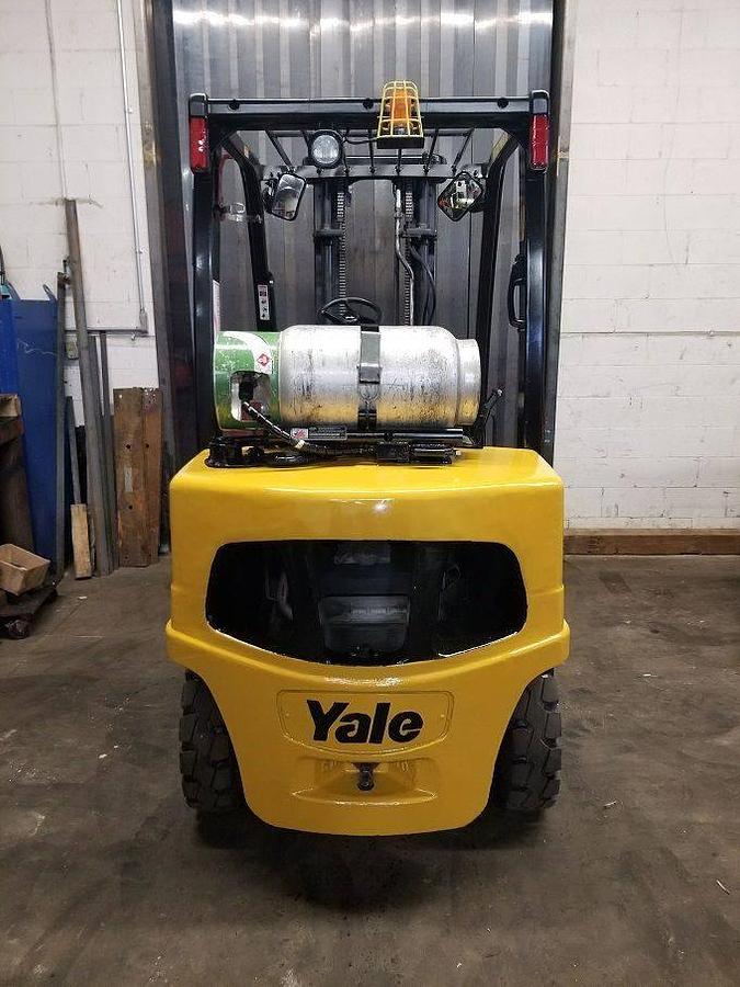 Rear view of refurbished 2013 Yale GLP060VX LPG pneumatic forklift showing counterweight, rear tires, and propane tank bracket during Brampton deployment