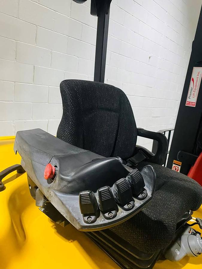 Close-up view of refurbished 2014 Yale ERC080VHN48TE100 electric cushion tire forklift showing mini stick hydraulic controls positioned beside operator seat, with CSA certification decal visible during Ontario deployment