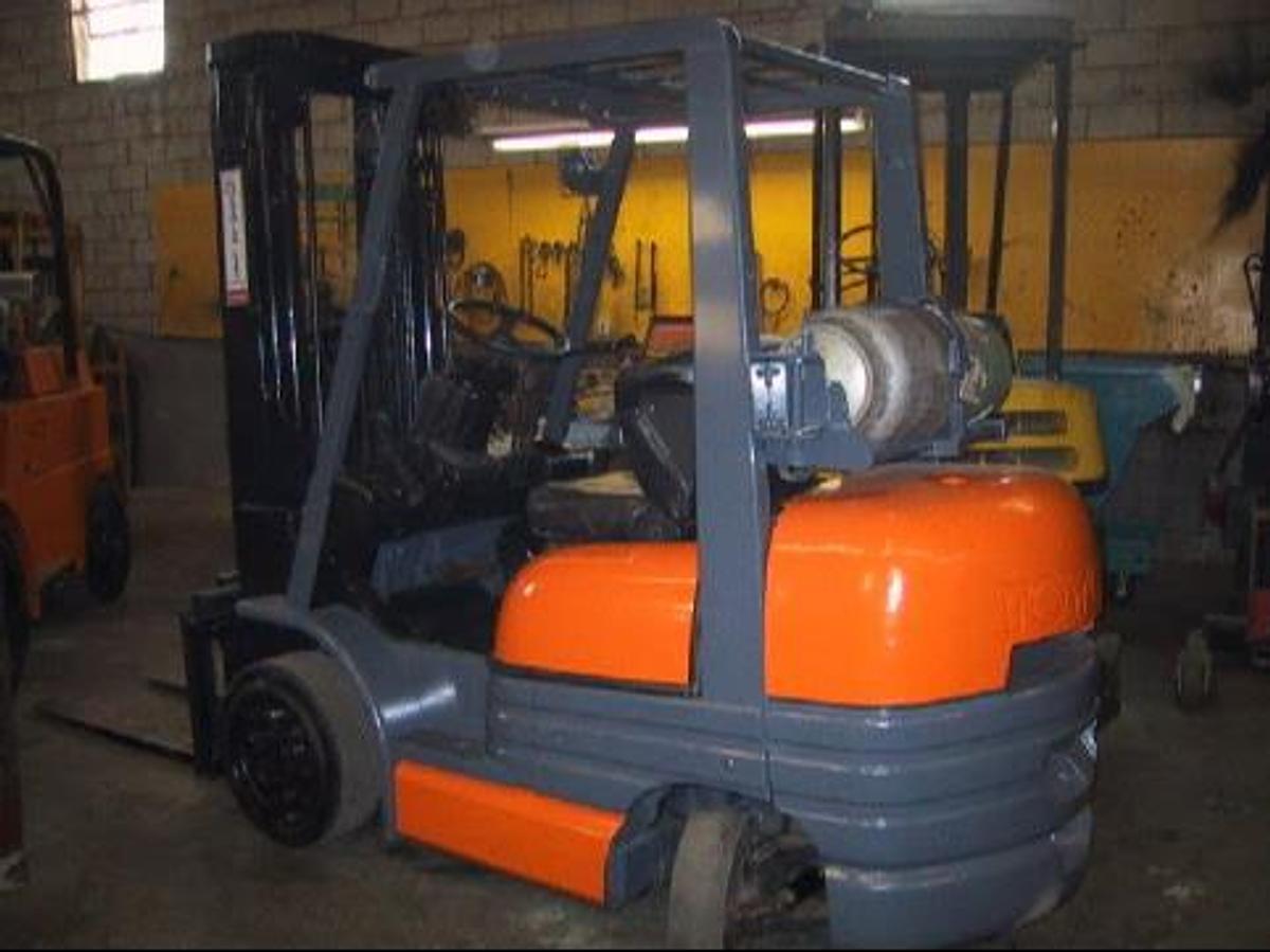 Rear view of vintage refurbished 1999 Toyota 42-6FGCU25 LP gas forklift showing counterweight, propane tank mount, and CSA inspection tag during Brampton deployment