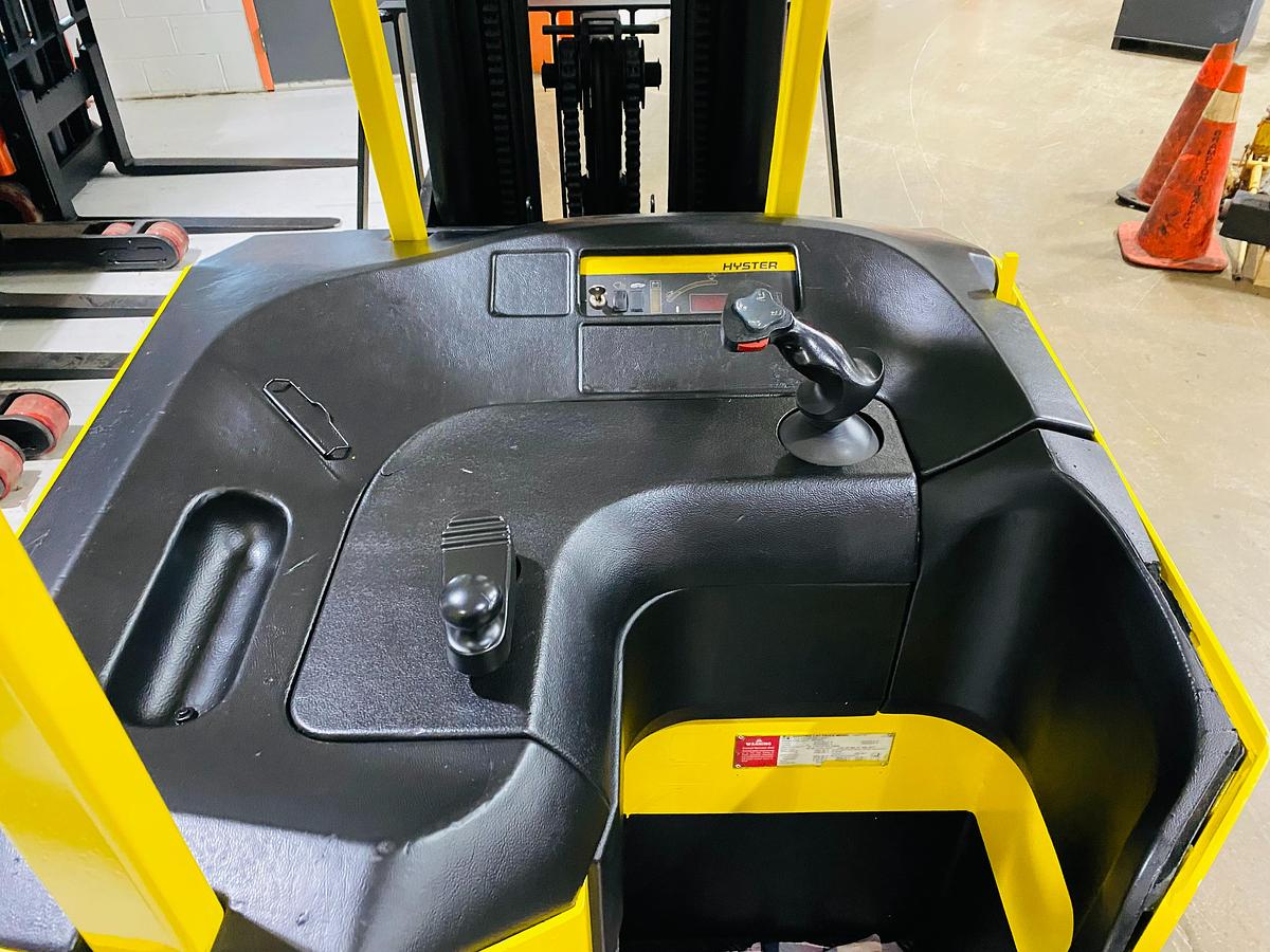 Top-down view of drive controls on Hyster E30FR-24 electric dockstocker showing ergonomic handle layout, directional switch, and deadman pedal – CSA-certified unit staged in Brampton ON
