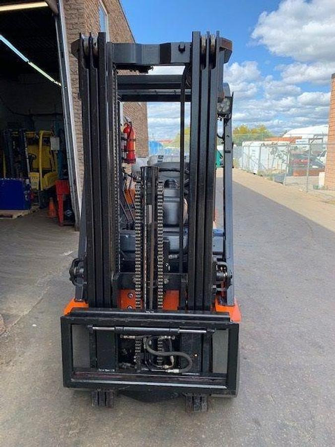 Front view of refurbished Toyota LP gas forklift showing triple mast and side shift carriage with forks removed during Brampton deployment