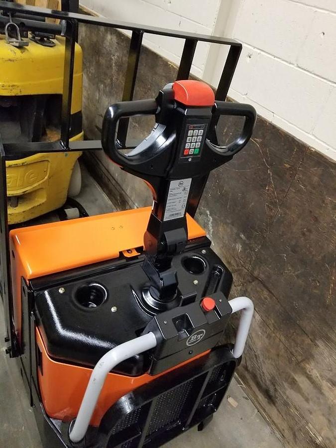 Operator compartment of refurbished 2011 BT LPE200/8 electric walkie/rider pallet jack showing controls, steering handle, flip‑down operator platform, and CSA certification decal during Ontario deployment.
