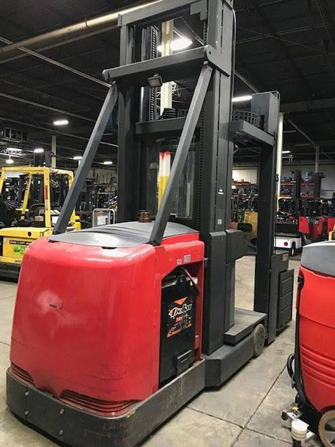 Rear angle side view of refurbished 2001 Raymond SA-CSR30TWG electric man-up turret truck showing operator platform, control panel, and rear chassis during Ontario deployment