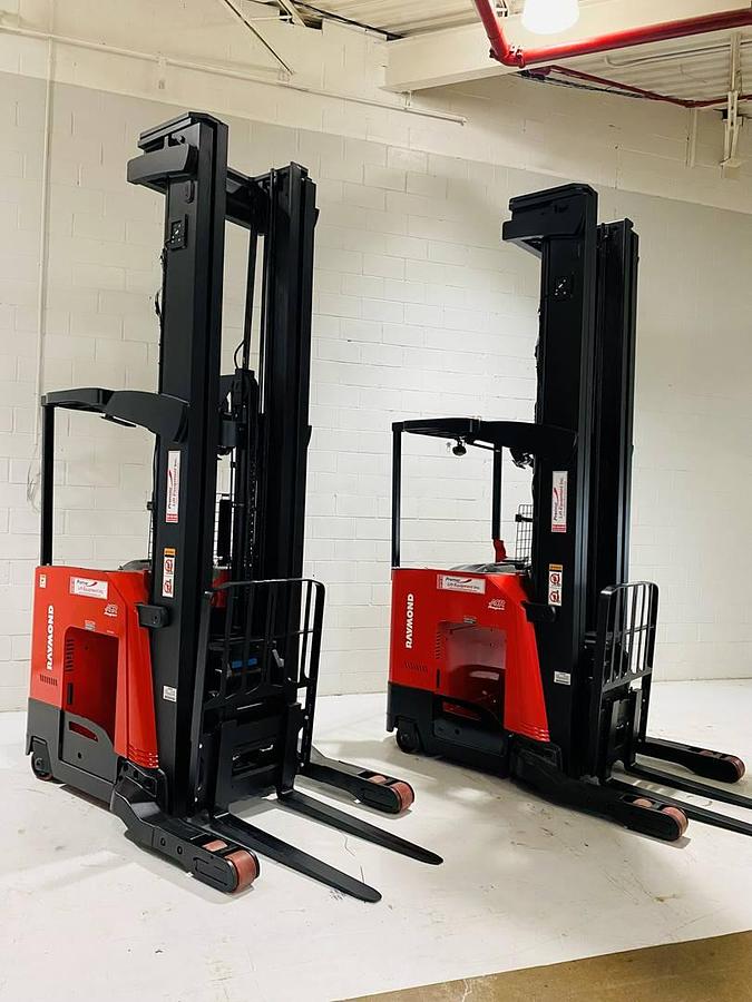Angled view of two 2022 Raymond 752-R45TT freezer reach trucks showing triple-stage masts, load backrests, and 42” forks – CSA certified units in Brampton ON