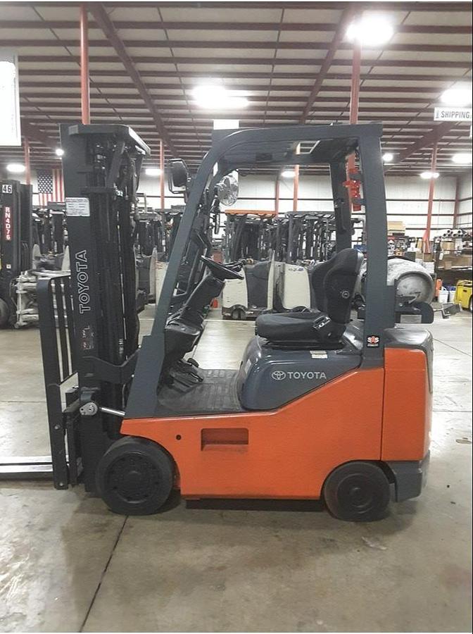 Opposite side view of refurbished 2014 Toyota 8FGCU18 LP gas forklift showing operator cab, rear chassis, and CSA decal during Brampton deployment