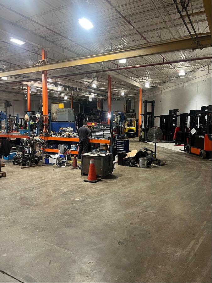 forklift technician performing shop repairs, CSA‑aligned service work