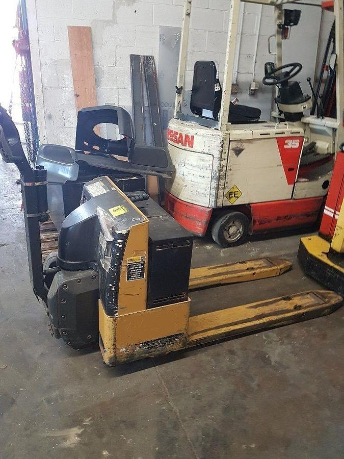Side view of refurbished 2004 Cat NPP40 electric walkie pallet jack showing 27" x 48" forks, reconditioned walk‑behind chassis, and CSA certification decal during Ontario deployment.