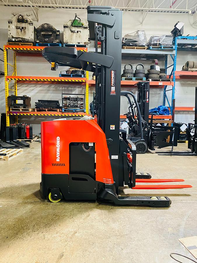 Side profile of Raymond 750DR32TT electric deep-reach forklift showing extended mast rails, reach mechanism, and chassis layout during Brampton deployment