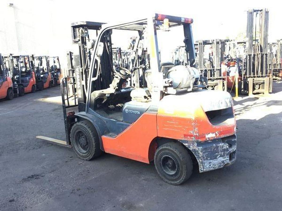 Back view of refurbished 2016 Toyota 8FGU30 LP gas forklift showing counterweight, propane tank mount, and CSA inspection tag during Brampton deployment