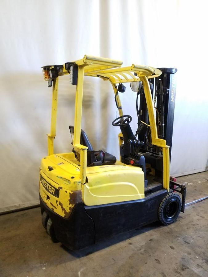 Opposite side view of refurbished 2014 Hyster J40XNT 3‑wheel electric forklift showing counterweight, operator compartment, 3‑stage mast, 42" forks, cushion tires, and CSA certification decal during Ontario deployment.