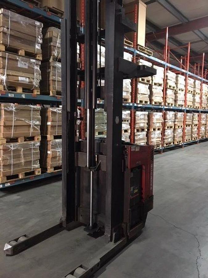 Front angle side view of refurbished 2007 Raymond EASIDR25TT electric double reach forklift showing fork tips, mast extension, and CSA certification decal during Ontario deployment