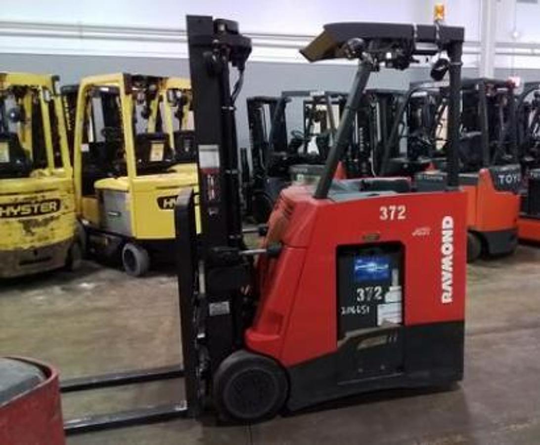 Opposite side view of Raymond 425-C35TT electric stand-up counterbalance forklift with battery installed – CSA-certified 3,500 lb chassis showing mast, forks, and operator station from alternate angle, staged in Brampton ON – Premier Lift Equipment