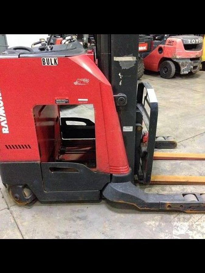 Side view of refurbished 2007 Raymond 740-R35TT electric reach truck showing battery enclosure, compartment door, and lower chassis panel during Toronto deployment