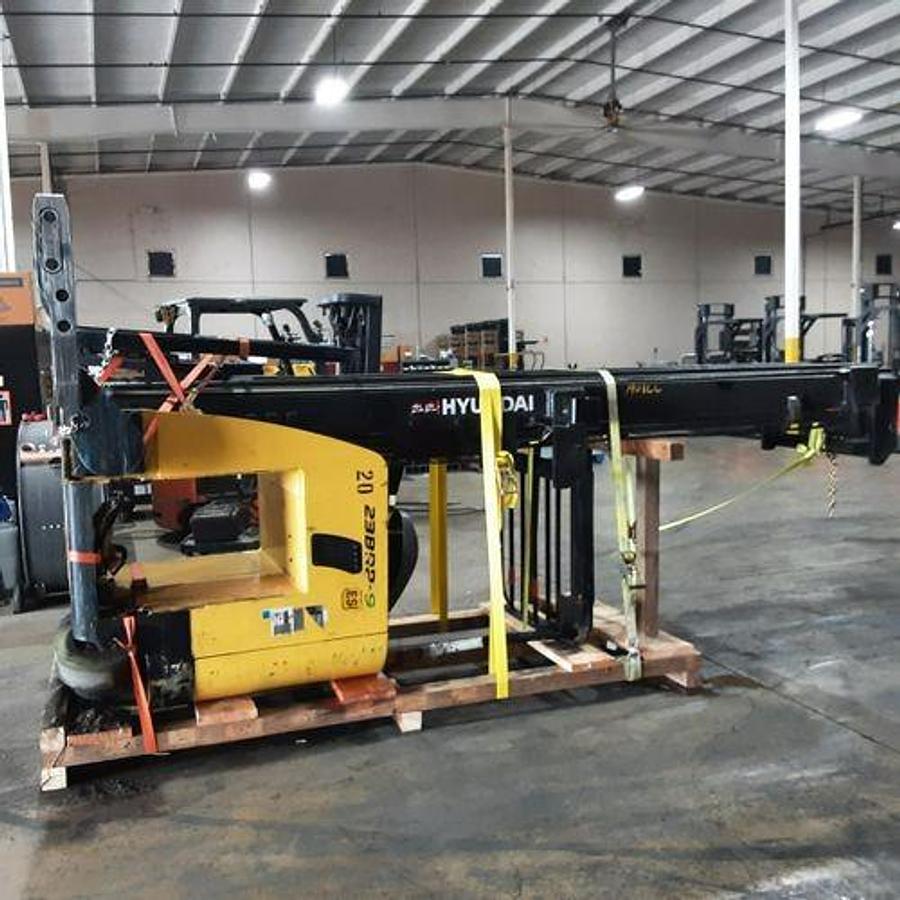 Side view of refurbished 2017 Hyundai 23BRP‑9 electric single reach truck chassis laid down and cradled, showing 42" base leg opening, 36 volt battery housing, solid frame supports, and CSA certification decal during Brampton deployment.