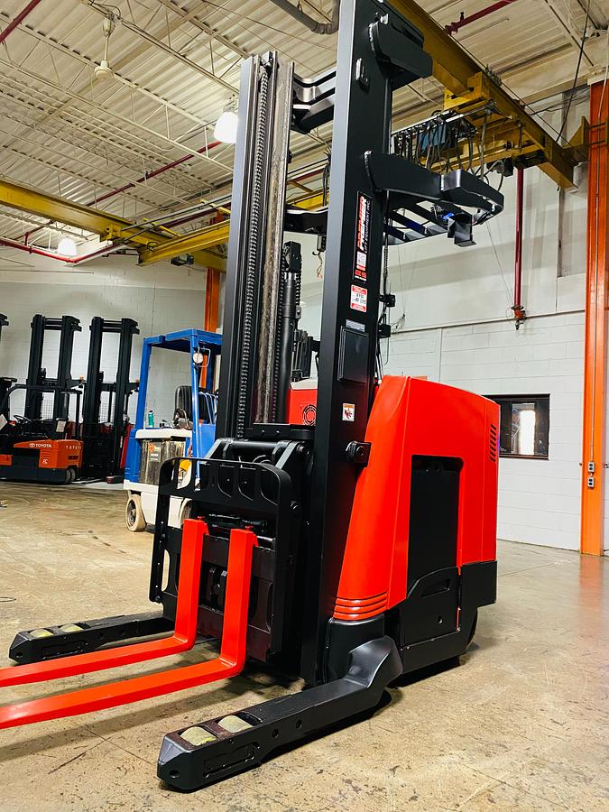Front side angle of Raymond 750DR32TT deep-reach forklift showing 264" triple mast, reach carriage, directional wheels, and narrow aisle chassis during Brampton deployment