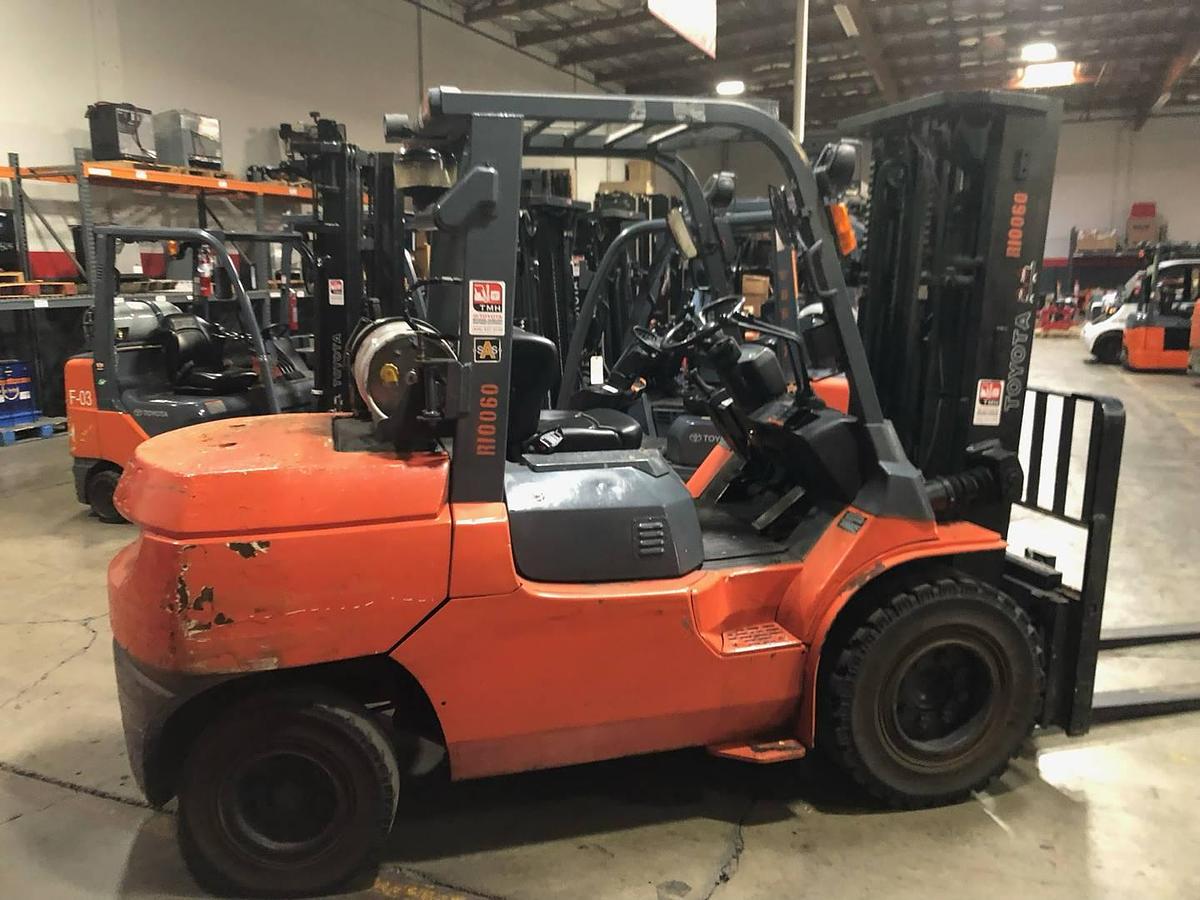 Side view of refurbished 2013 Toyota 7FGU45 LP gas forklift showing operator cab, chassis, and triple mast during Brampton deployment