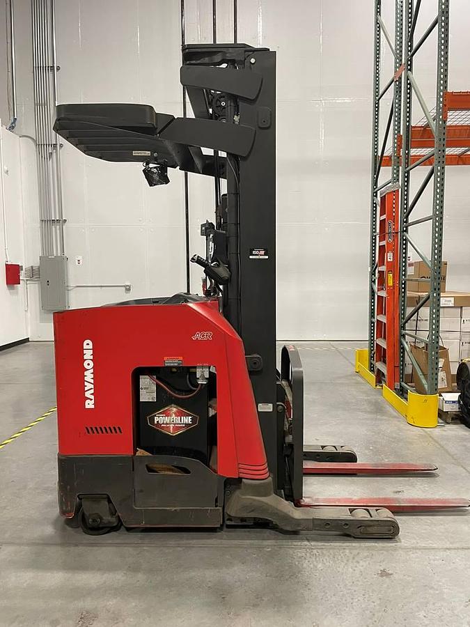 Side view of refurbished 2021 Raymond 730-R35TT electric reach truck showing 16" battery box, chassis frame, and forward-facing operator cab during Oakville deployment