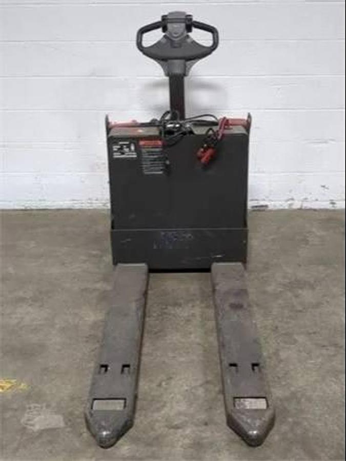 Front view of refurbished 2018 Raymond 8250 electric walkie pallet truck showing 27" x 46" forks, fork heels, and front chassis panel during Mississauga deployment
