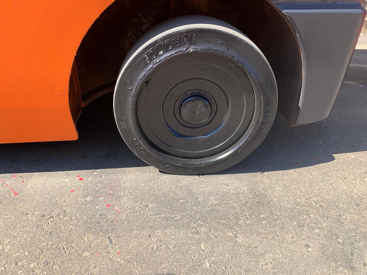 Left cushion steer tire showing wheel hub and CSA spec