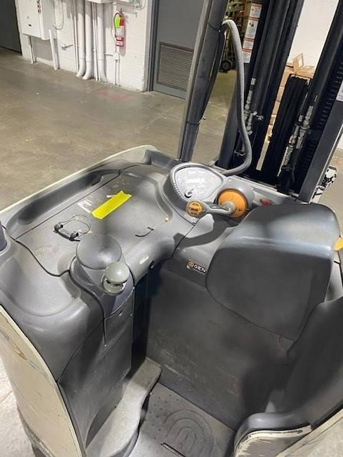Operator compartment of refurbished 2017 Crown RC5545‑40 electric forklift showing seat, steering wheel, hydraulic levers, 36 volt controls, and CSA certification decal during Ontario deployment.