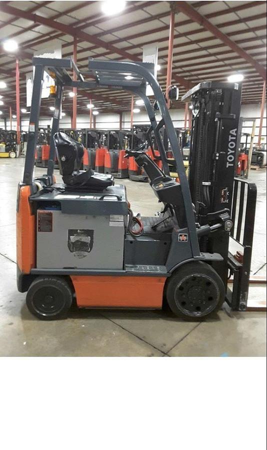 Profile view of 2012 Toyota 8FBCU25 electric forklift showing 4-wheel chassis, battery compartment, and side shift carriage