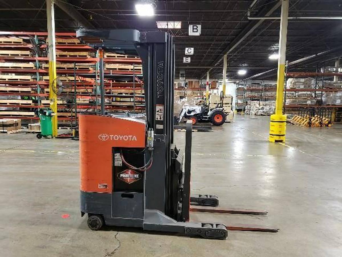 Side view of refurbished 2008 Toyota 7BRU18 electric reach truck showing quad mast, CSA decal, and 42" forks during Ontario deployment