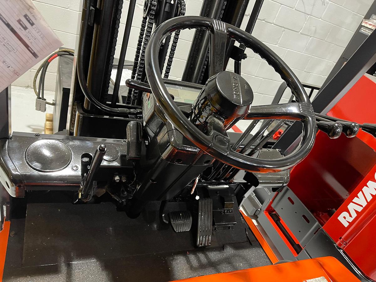 Operator compartment view showing suspension seat and LCD dash