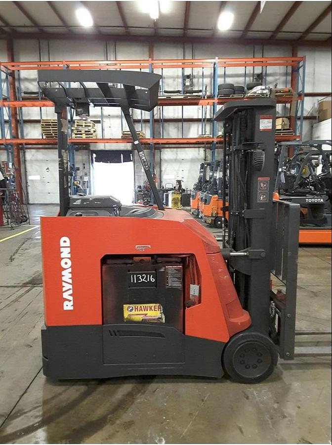 Side view of refurbished 2011 Raymond 425-C50TT electric docker showing battery compartment, chassis frame, and triple mast during Concord deployment