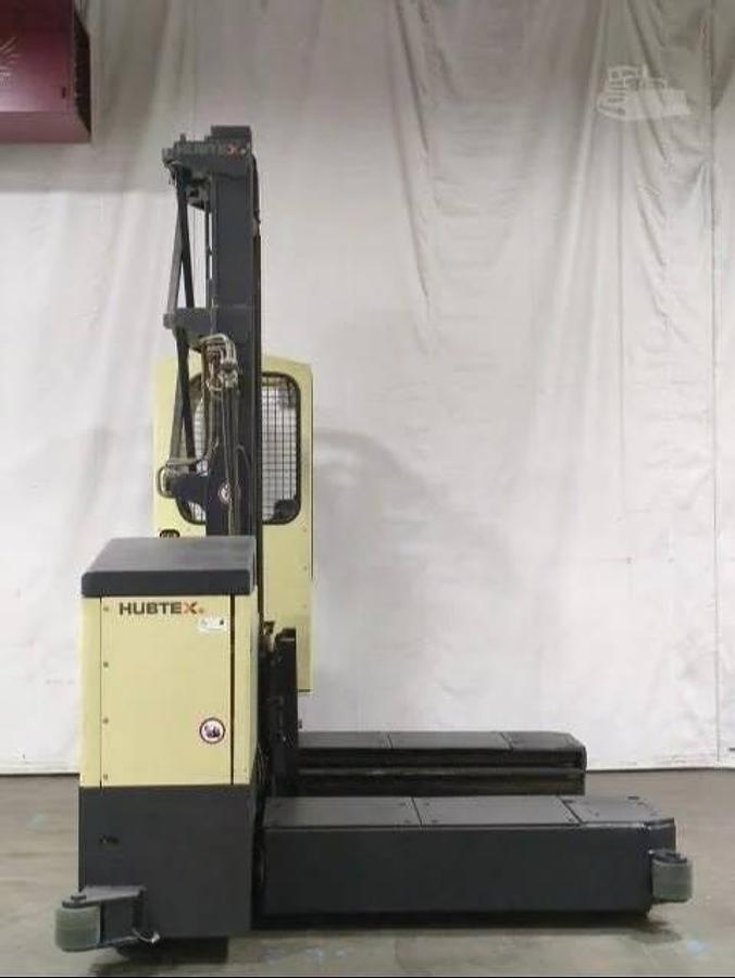 Side view of Hubtex MQ45 electric multidirectional sideloader showing 60” forks, mast carriage, and CSA-certified chassis – unit staged in Brampton ON