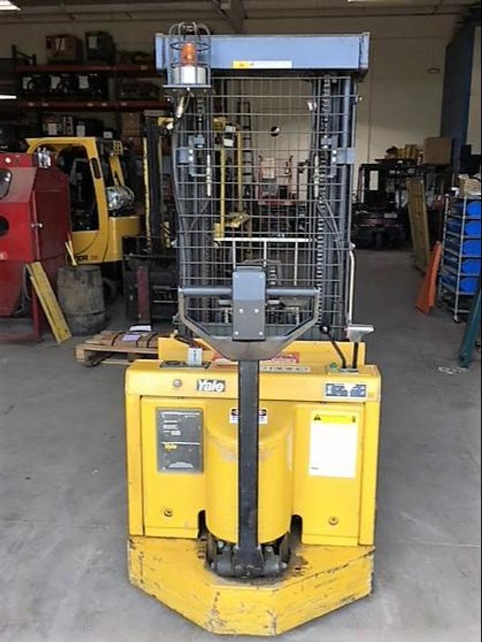 Back view of refurbished 1997 Yale MRW030 electric walkie straddle stacker reach showing counterweight, rear tires, and CSA certification decal during Ontario deployment.