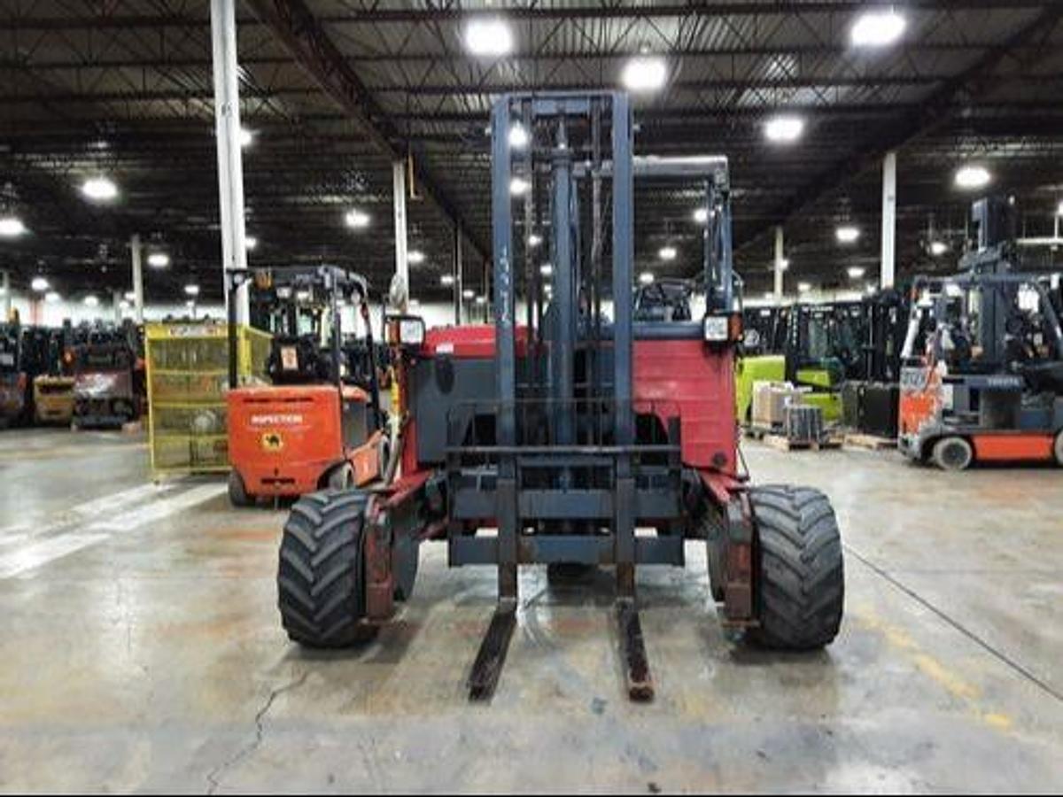 Front view of Moffett M8 55.3NX truck-mounted diesel forklift showing 48” forks, mast carriage, load backrest, and CSA-certified chassis – unit staged in Brampton ON